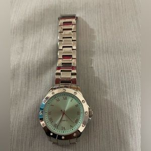 Quartz watch with light green face and CZs around the face
